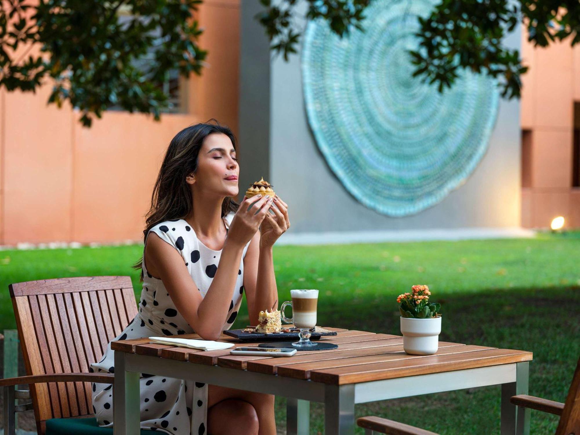 Swissôtel Grand Efes Izmir Esmirna Exterior foto A woman eating a meal